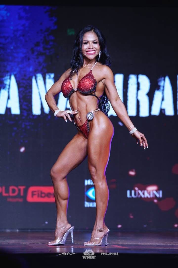Jasmin on stage with the WNBF Philippines backdrop behind her