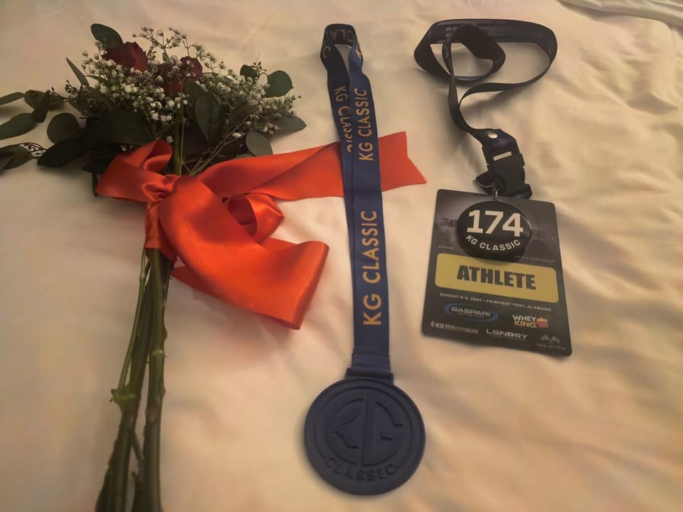 Jasmin's competition medal and athlete badge next to a bouquet of roses