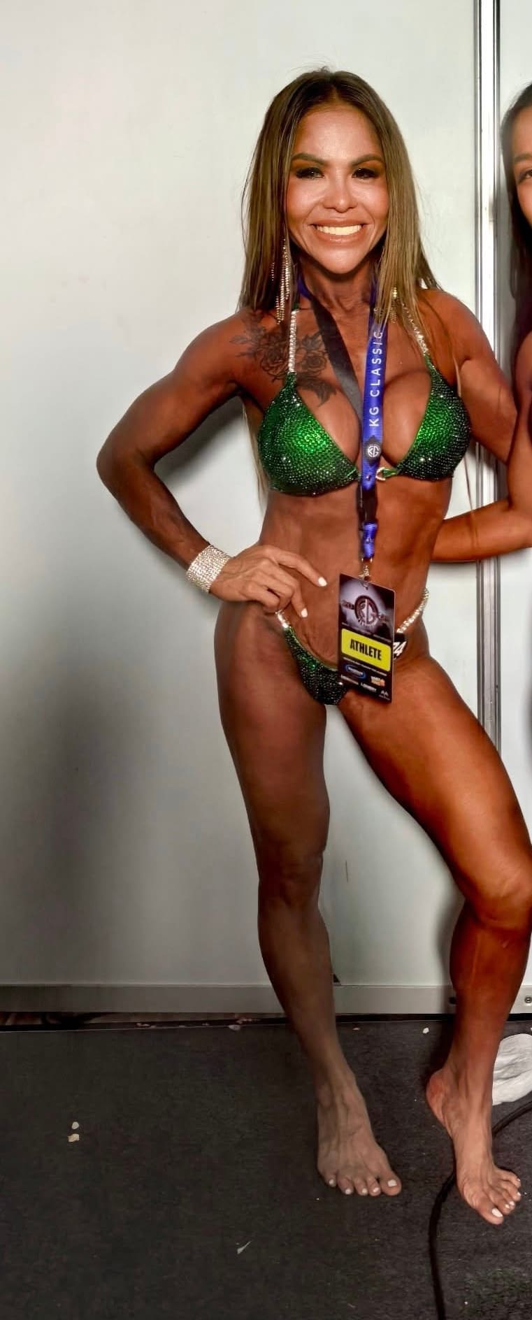 Jasmin backstage in her green competition suit